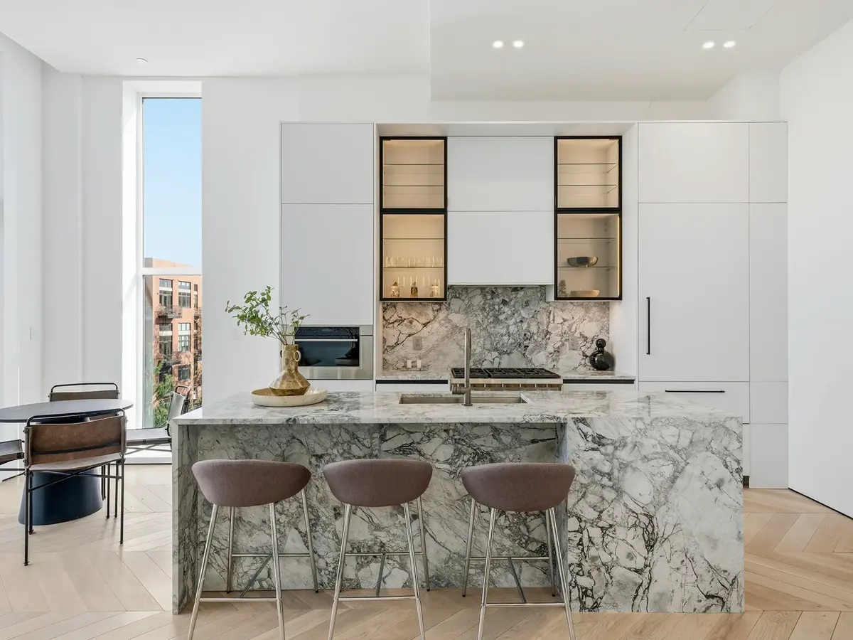 Modern white HDR-photographed kitchen in a New York City condo listing.