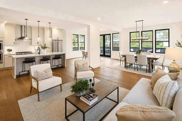 Modern living room interior with a cozy sofa, plants, and large windows, ideal for a real estate floor plan service blog