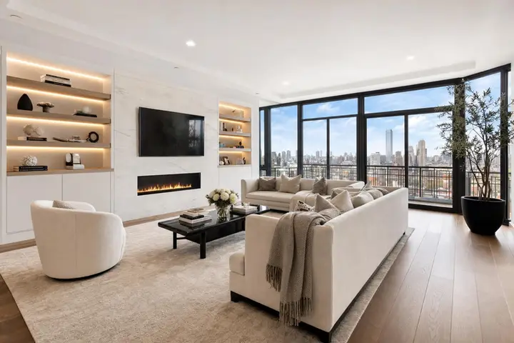 Elegant living room with floor-to-ceiling windows, modern furnishings, and a spacious open layout in a luxury home