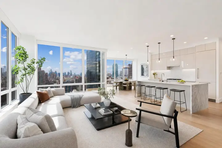 Bright modern living room with large windows, stylish furniture, and city views, ideal for real estate photography services NYC