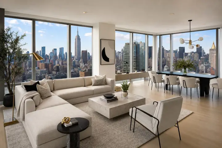 Luxurious NYC apartment interior with a spacious living area, modern furniture, and large windows offering a city skyline view.