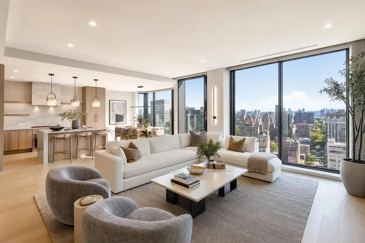 Spacious modern living room with elegant décor, large windows, and upscale furnishings, showcasing luxury real estate photography