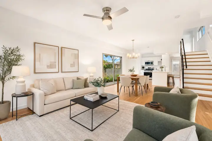 Bright, modern living room featuring large windows, elegant furnishings, and natural light, ideal for real estate photography