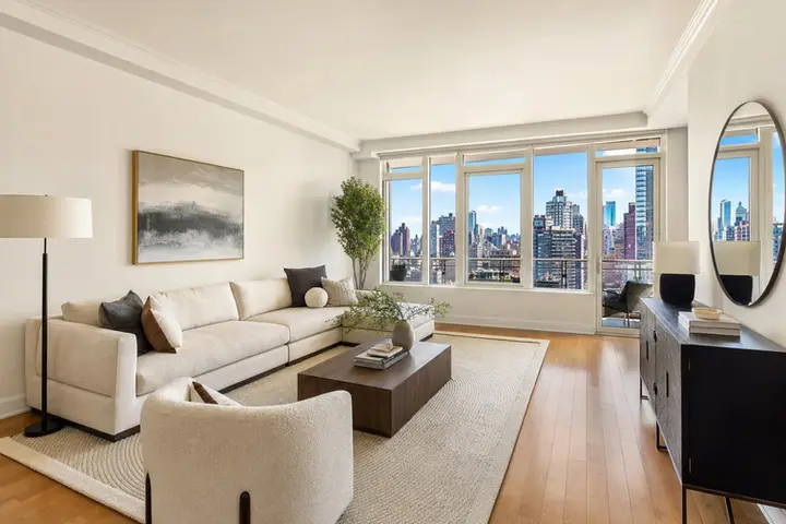Modern living room with stylish furniture, large windows, and natural light, showcasing real estate photographer quality