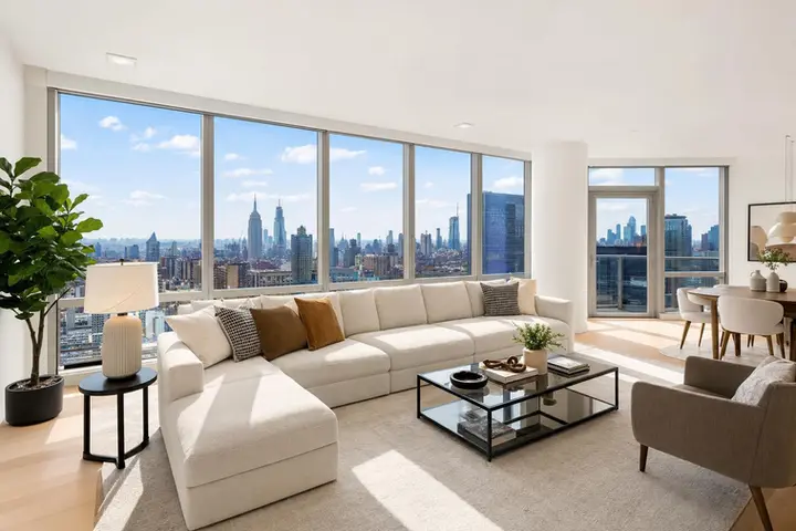 Spacious modern living room with large windows, sleek furniture, and city views, ideal for showcasing a 3d virtual tour