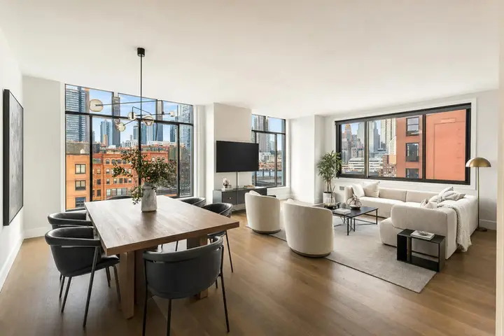 Spacious modern living room with large windows, elegant furnishings, and natural light, showcased using Zillow 3D tour technology