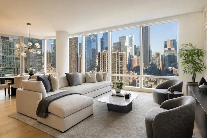 Spacious modern Manhattan apartment interior with large windows, natural light, and stylish furnishings