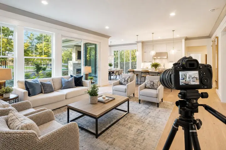Modern living room with stylish furniture, large windows, and bright natural light, highlighting expert real estate photographer work