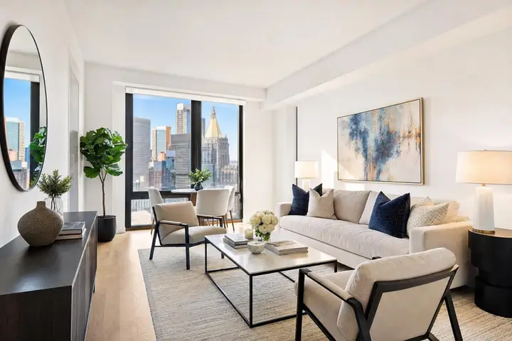 Bright, modern living room with large windows, stylish furniture, and city views, perfect for real estate photography NYC