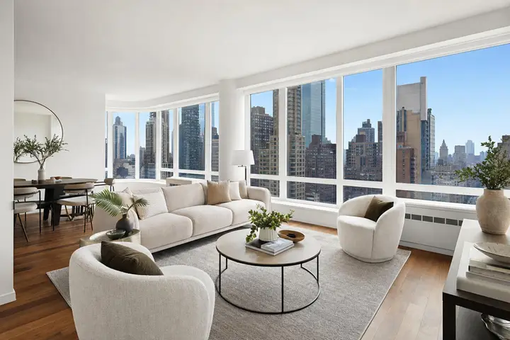 Modern living room with large windows, stylish decor, and natural light, reflecting real estate photography NYC style
