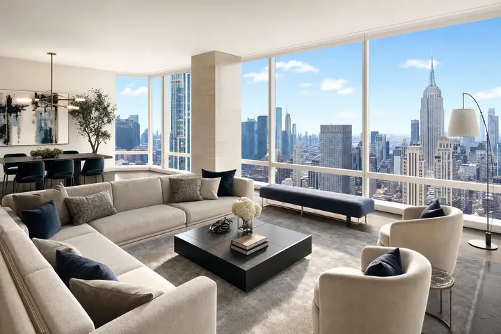 Modern living room with large windows showcasing a stunning Manhattan skyline view and elegant decor.