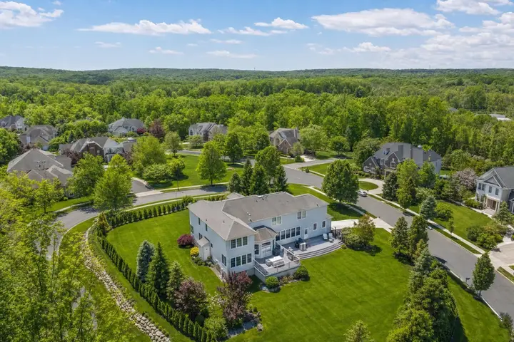 Aerial view of a residential property with lush green lawn and driveway, captured by drone photography NJ for real estate listings