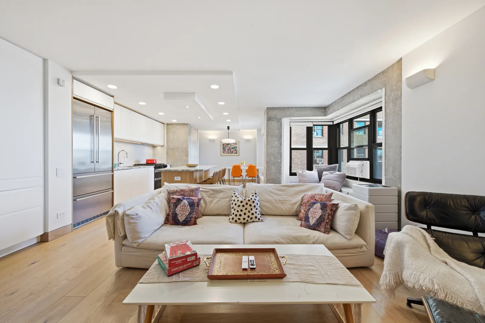 Bright NYC dining and living area by RealtaSnap